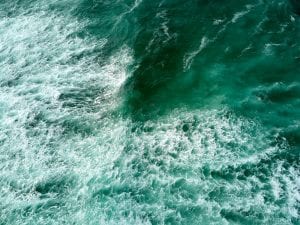 Drone shot of ocean and waves. High angle view of water during a sea storm.