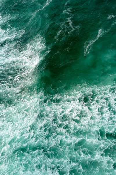 Drone shot of ocean and waves. High angle view of water during a sea storm.